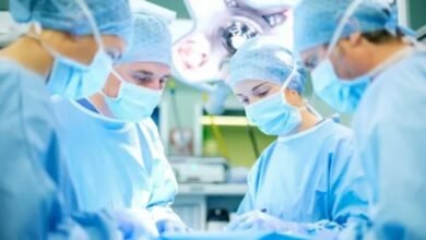 A team of surgeons collaborates in a sterile operating room, focused on a surgical procedure.