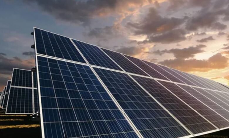 Solar panels in a field basking in the warm glow of a sunset, highlighting renewable energy's beauty and potential.