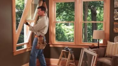 A man carefully installs a window in a room, ensuring a precise fit and proper alignment for optimal functionality.