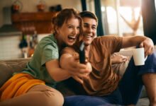 a couple sitting together and watching tv