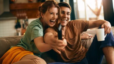 a couple sitting together and watching tv