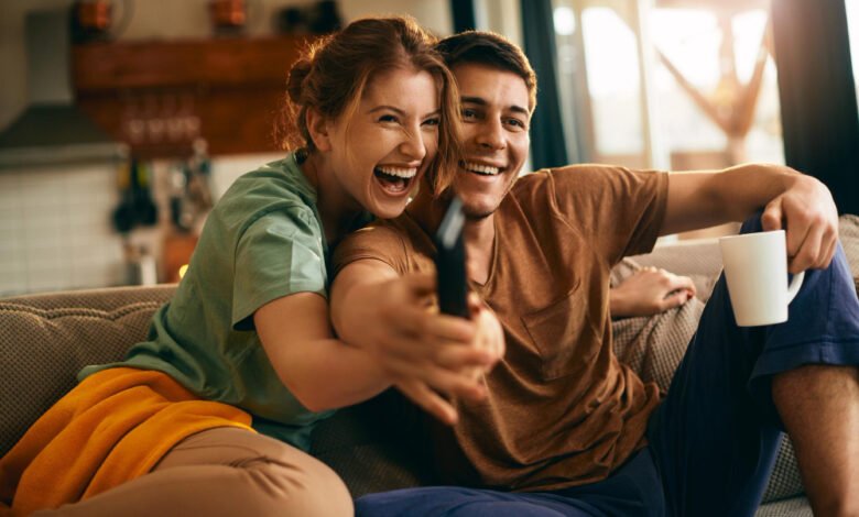 a couple sitting together and watching tv