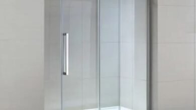 A sleek glass shower door featuring a modern sliding mechanism for easy access and a contemporary aesthetic.