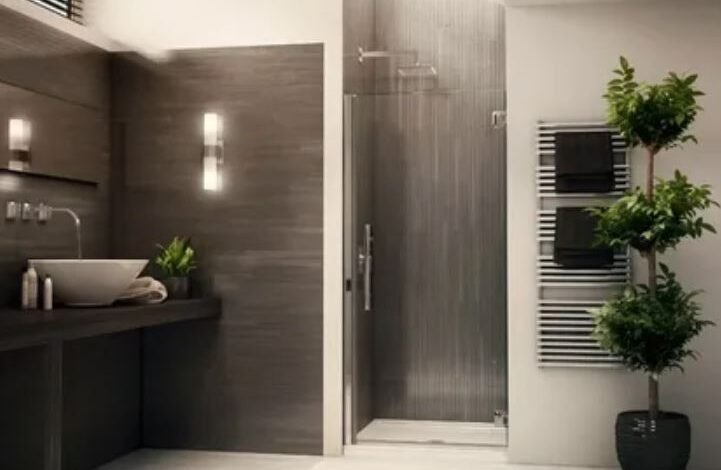 A sleek modern bathroom featuring a contemporary shower and a stylish sink, showcasing minimalist design elements.