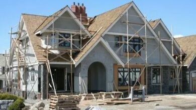 A house under construction, featuring scaffolding and wooden beams, showcasing the building process.